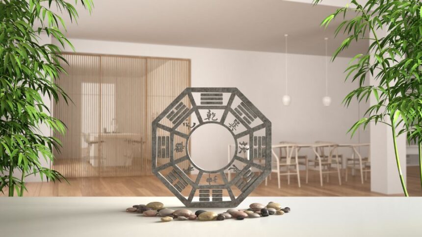 Egy feng shui szimbólum, amely harmonikus energiát sugároz, zöld növényekkel és sima kövekkel körülvéve.