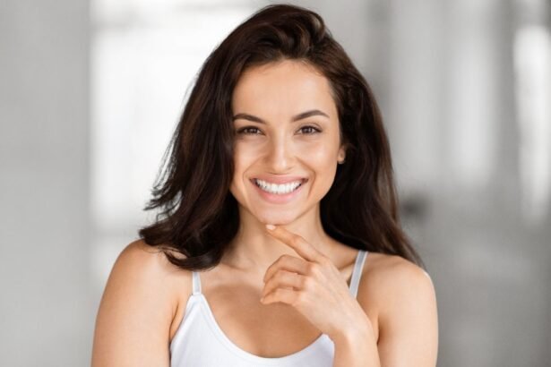 Egy magabiztos nő mosolyog, kezével az állát támasztja, sugárzó önbizalommal.