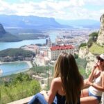 Két lány gyönyörködik a panorámás kilátásban egy hegyi helyszínen.