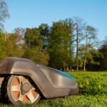 Robotfűnyíró a zöld gyepen, modern kertápolási megoldás